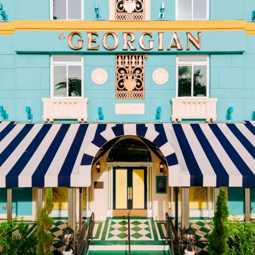 The image shows the entrance of a building labeled "Georgian," featuring blue walls, a striped awning, and decorative elements on the facade.