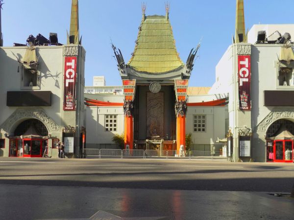 This image shows a famous theater with ornate architecture and a star on the sidewalk in front.