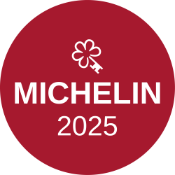 Michelin 2025 badge: a red circular sticker with a white clover symbol and the text “MICHELIN 2025” in bold lettering.