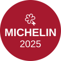 Michelin 2025 badge: a red circular sticker with a white clover symbol and the text “MICHELIN 2025” in bold lettering.