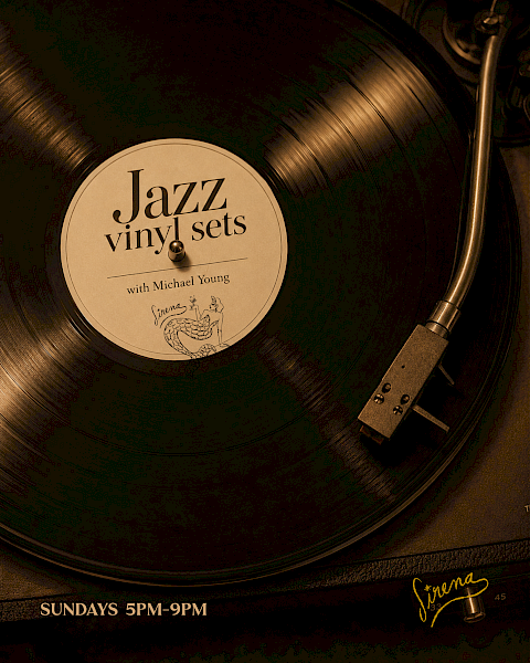 A close-up of a spinning vinyl record on a turntable, label reads &ldquo;Jazz vinyl sets,&rdquo; with text &ldquo;Sundays 5PM-9PM&rdquo; and a signature at the bottom.