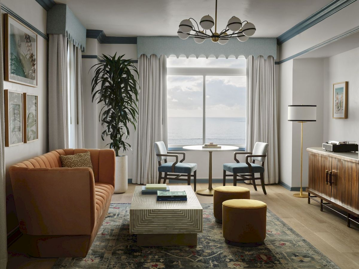 Contemporary living room with a large window, mid-century sofa, two chairs at a round table, tall plant, neutral rug, wooden sideboard, and warm lighting.