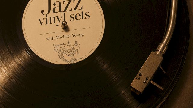 A vinyl record labeled &ldquo;Jazz vinyl sets,&rdquo; with a needle/turntable arm, plus text &ldquo;Sundays 6PM&ndash;10PM,&rdquo; all golden-toned.